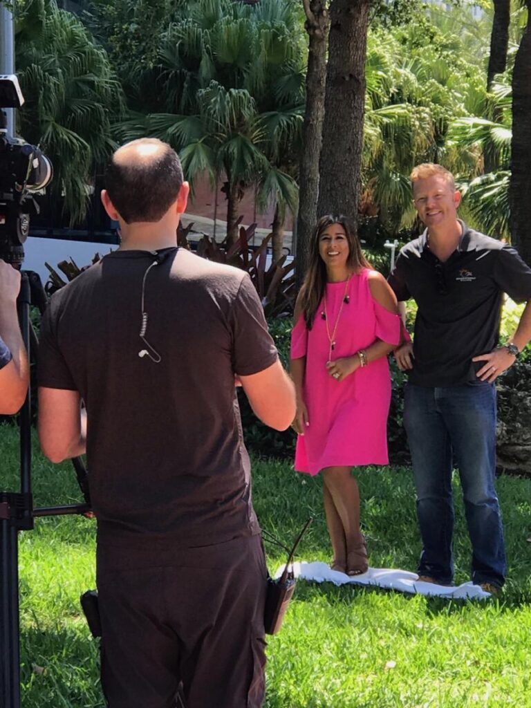A camera operator filming David and Ivana Shoultz outdoors