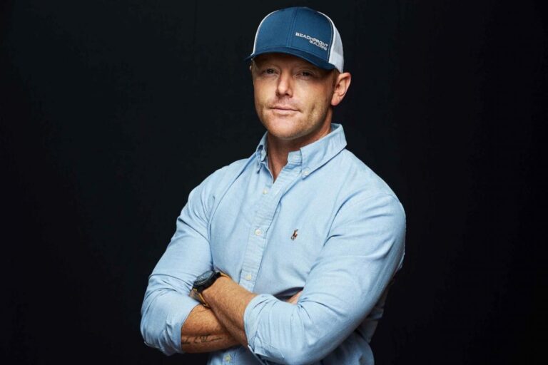 Studio portrait of David Shoultz in a Beachfront Builders cap
