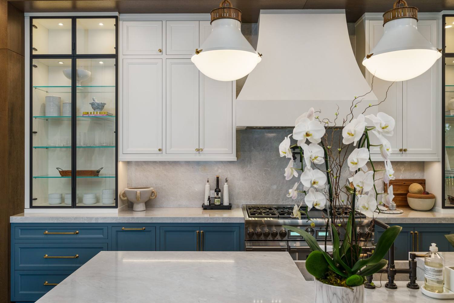 Custom kitchen with blue lower cabinets, white uppers and range hood
